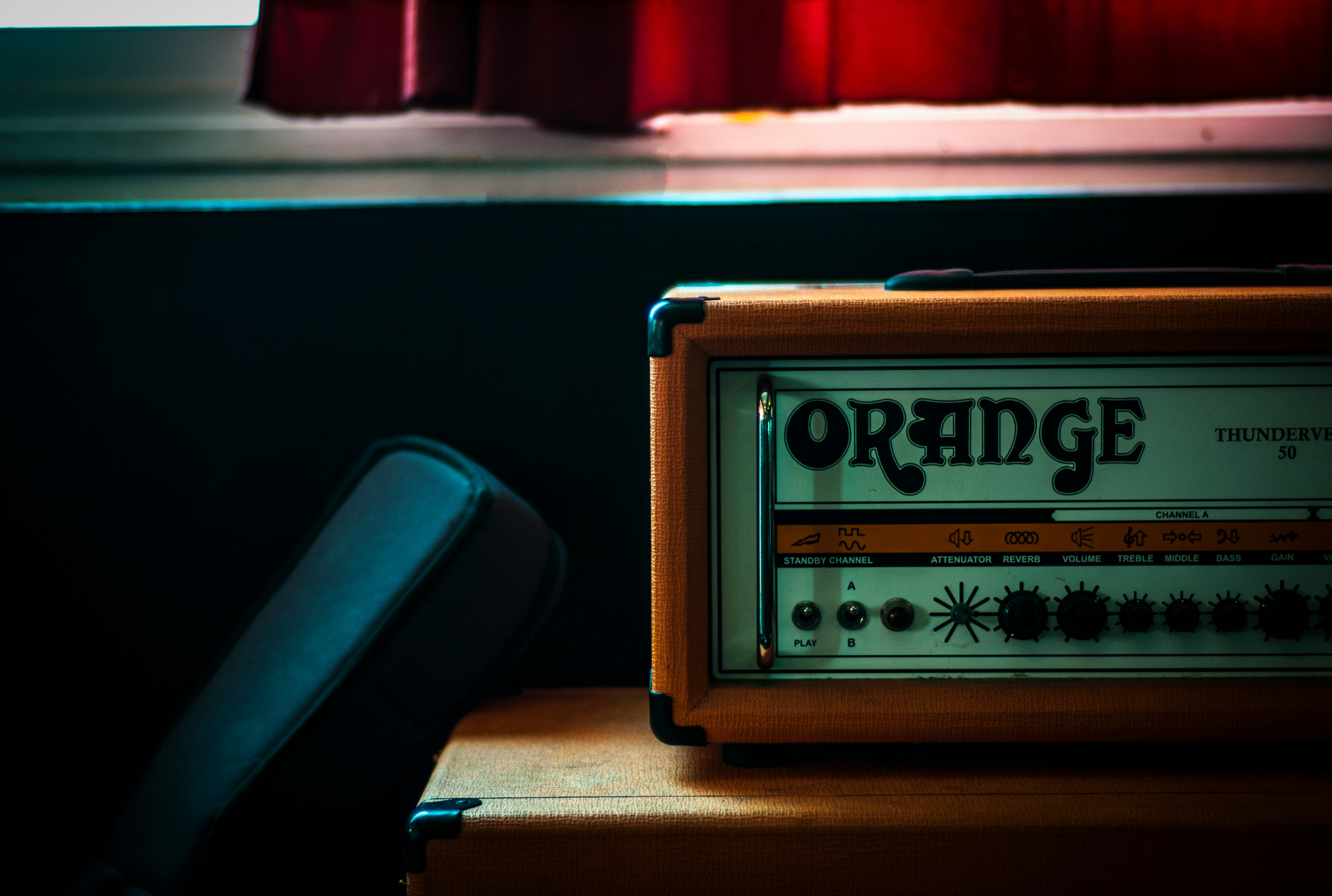 orange and gray Orange radio on brown wooden plank